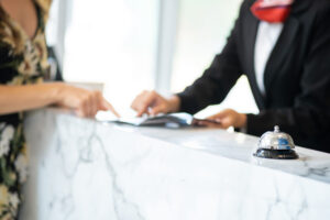 A hotel concierge explaining information to a guest at the counter